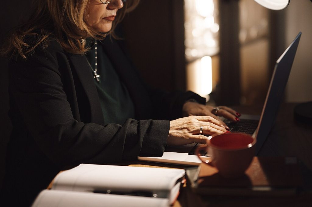 Nex777 Platform Features: Exploring Its Interface and User Experience Woman typing on a laptop at a home office desk while using an online platform